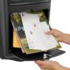 Open black wall mount mailbox with mail inside