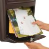 Open brown wall mount mailbox with mail inside