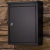 Black wall mount mailbox on wall