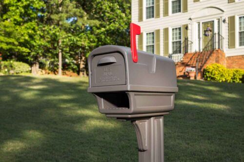 Zoomed in image of brown mailbox in front of house