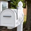 Side of white post mount mailbox with flag raised